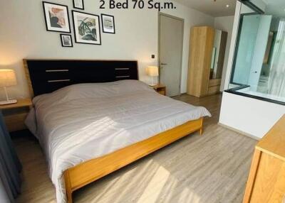 Spacious bedroom with double bed, large windows, and modern furnishings