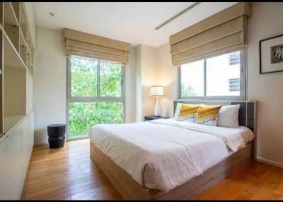 Spacious bedroom with large windows and a double bed