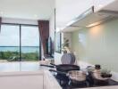 Modern kitchen with cookware, stove, and a scenic view