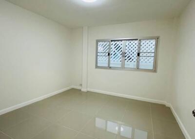 Empty bedroom with tiled floor and window