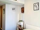 Modern bedroom with a small dressing table and framed pictures on the wall