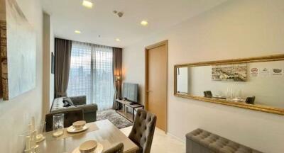 Modern living room with dining area and natural light