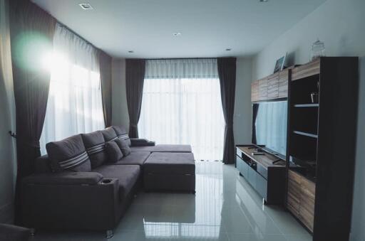 Modern living room with sectional sofa and entertainment unit