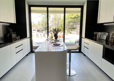 Modern kitchen with island and large windows