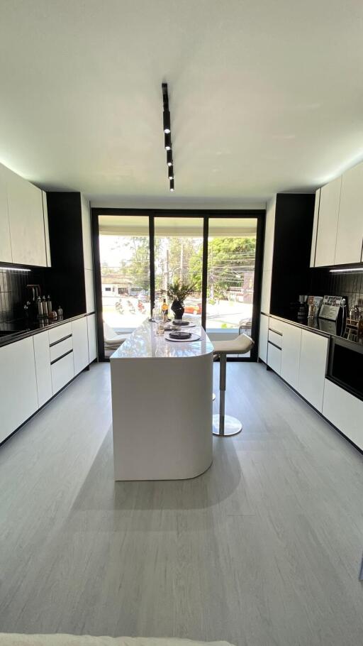 Modern kitchen with island and large windows