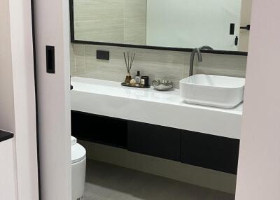 Modern bathroom with large mirror and floating vanity