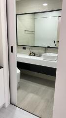 Modern bathroom with large mirror and floating vanity