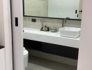 Modern bathroom with large mirror and floating vanity