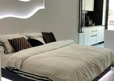 Modern bedroom with minimalist design, featuring a floating bed with LED lighting