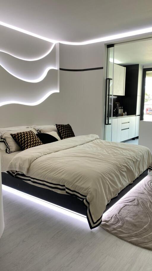 Modern bedroom with minimalist design, featuring a floating bed with LED lighting