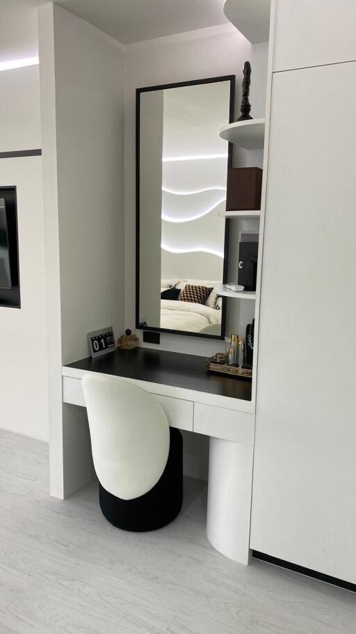 Vanity area with a mirror and chair in modern bedroom