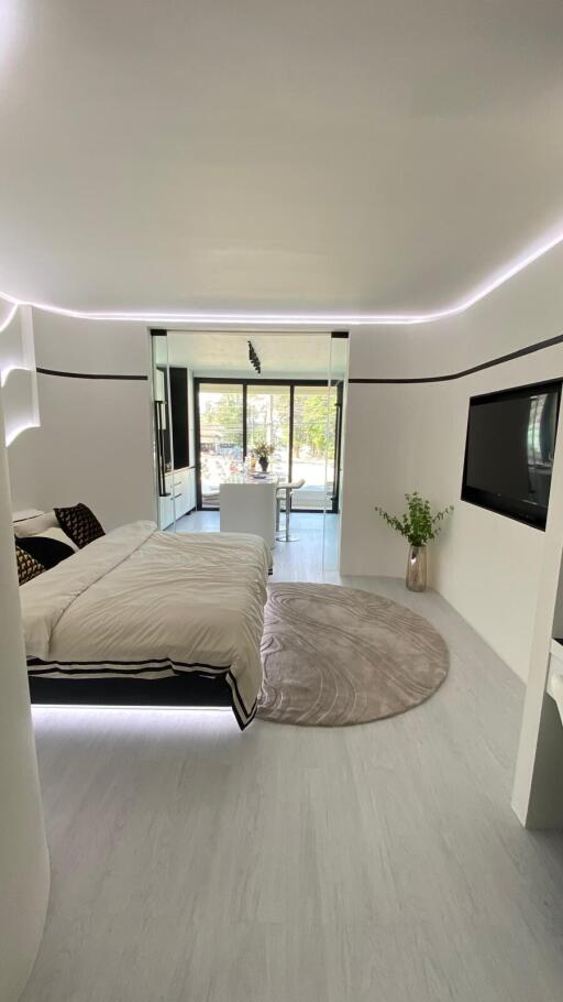 Modern bedroom with minimalist design, floating bed, and natural light