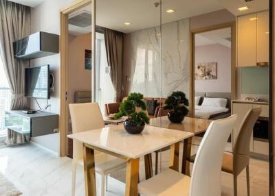 Dining area with table and chairs, adjacent to living room and bedroom