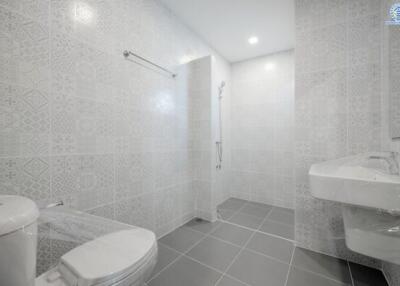 Modern bathroom with shower and large tiles