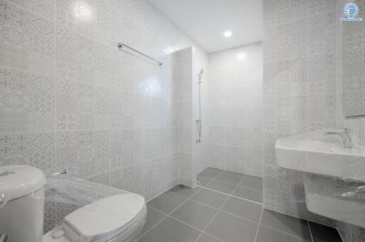 Modern bathroom with shower and large tiles