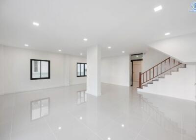 Spacious main living area with polished floors and modern lighting