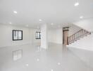 Spacious main living area with polished floors and modern lighting