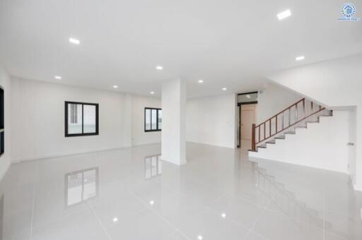 Spacious main living area with polished floors and modern lighting