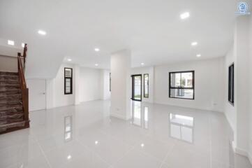 Spacious living room with tiled floor and large windows