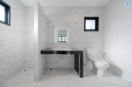 Bathroom with modern fixtures and marble tiles