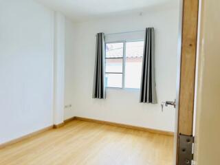 Empty bedroom with window and curtains