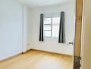 Empty bedroom with window and curtains