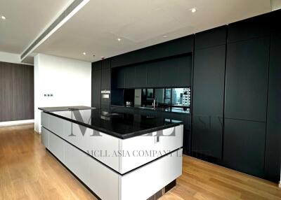 Modern kitchen with black cabinetry and island counter