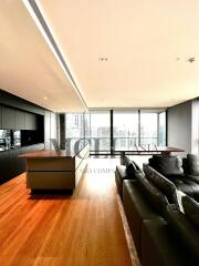 Modern living room with wooden flooring and large windows