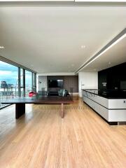 Modern living space with city view, wooden flooring, dining area, and open kitchen