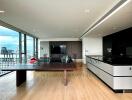 Modern living space with city view, wooden flooring, dining area, and open kitchen