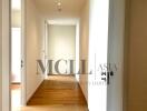 well-lit hallway with wooden floors