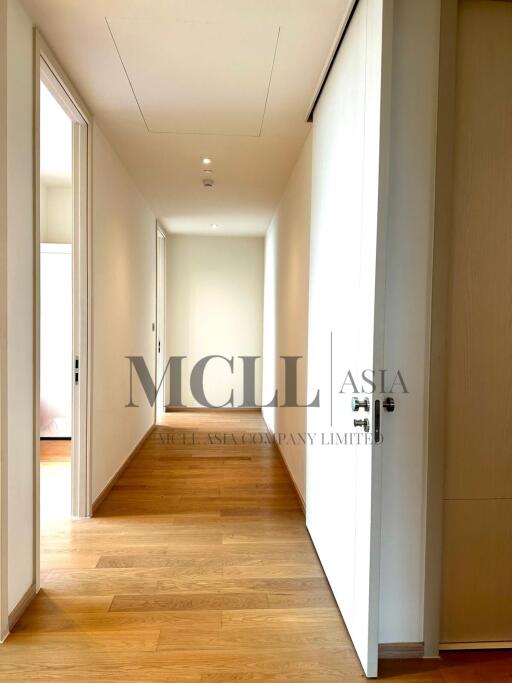 well-lit hallway with wooden floors