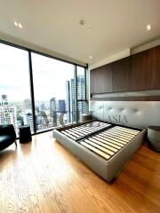 Modern high-rise bedroom with large windows and city view