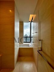 Modern bathroom with wooden accents and large window