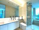 Modern bathroom with large mirror and glass-enclosed shower