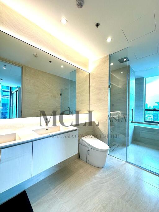 Modern bathroom with large mirror and glass-enclosed shower