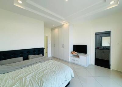 Spacious bedroom with modern furnishings and en-suite bathroom