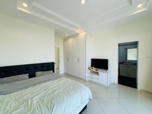 Spacious bedroom with modern furnishings and en-suite bathroom