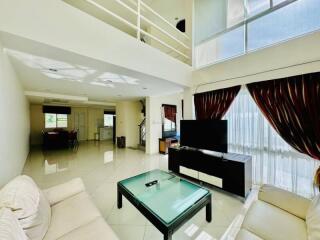 Spacious living room with modern furniture and high ceiling