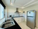 Modern kitchen with stainless steel appliances and black countertops