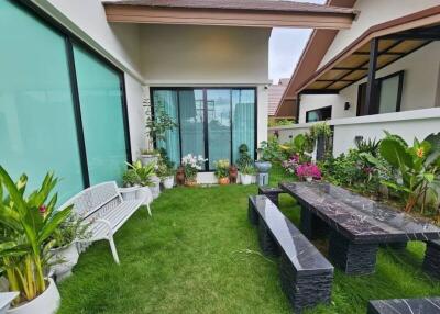 beautifully landscaped garden with a seating area