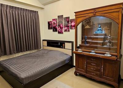 Bedroom with wooden furniture and decorative items