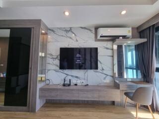 Modern living room with wall-mounted TV and air conditioner