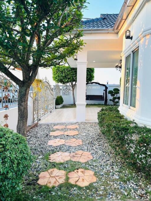 Beautiful garden path leading to a covered patio area