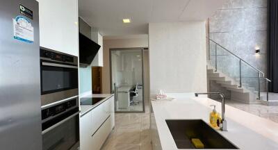 Modern kitchen with white cabinetry and stainless steel appliances