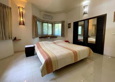 Spacious bedroom with large windows and a double bed