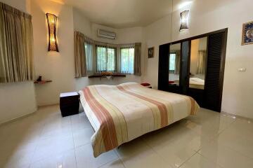 Spacious bedroom with large windows and a double bed