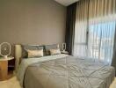 Comfortable and modern bedroom with large window and double bed