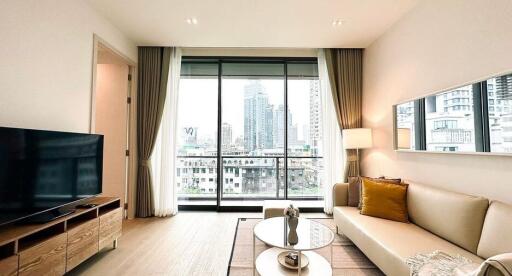 Spacious living room with a large window and city view