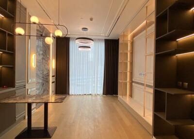 Modern dining room with built-in shelves and a contemporary chandelier